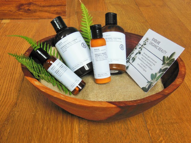 Evolve Organic Beauty products in a wooden bowl