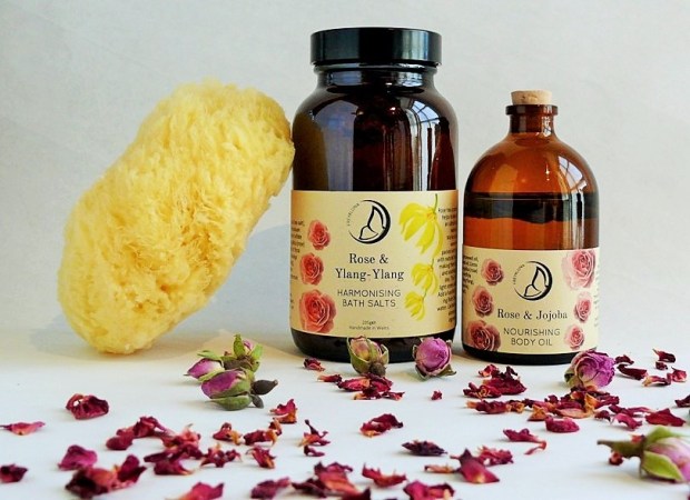 Freyaluna Rose Ylang-Ylang Bath Salts and Rose Jojoba Body Oil with sea sponge and rose petals