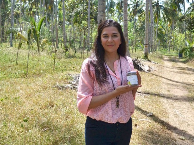 Ria Pattni co-founder of Fushi holding a beauty product