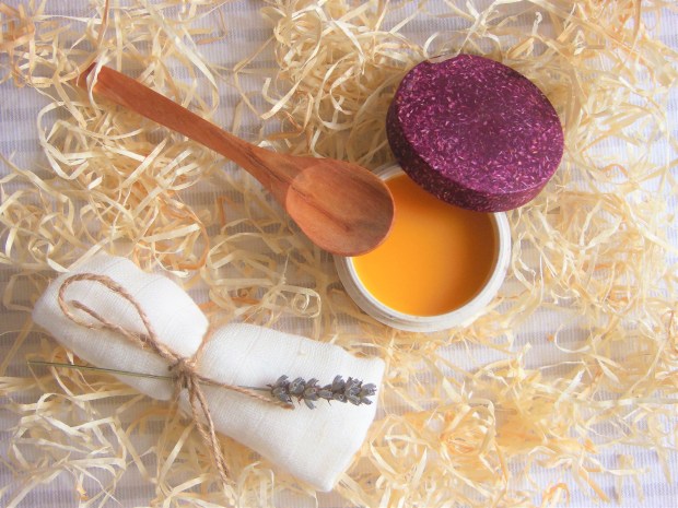 Happi Body Co Cleansing Melt open pot with wooden spoon and cloth