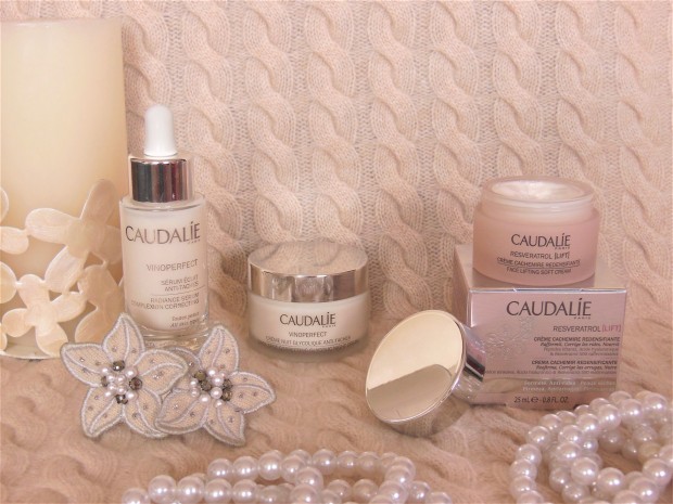 Caudalie skincare products on cashmere background