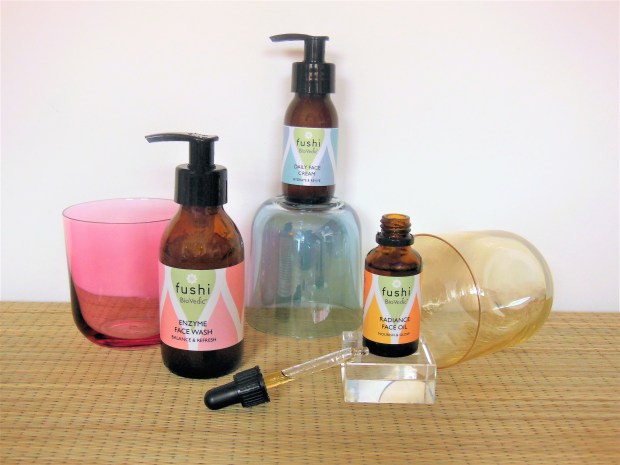 Three natural skincare products with coloured glasses