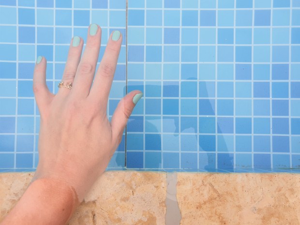 Aqua manicure hand in swimming pool