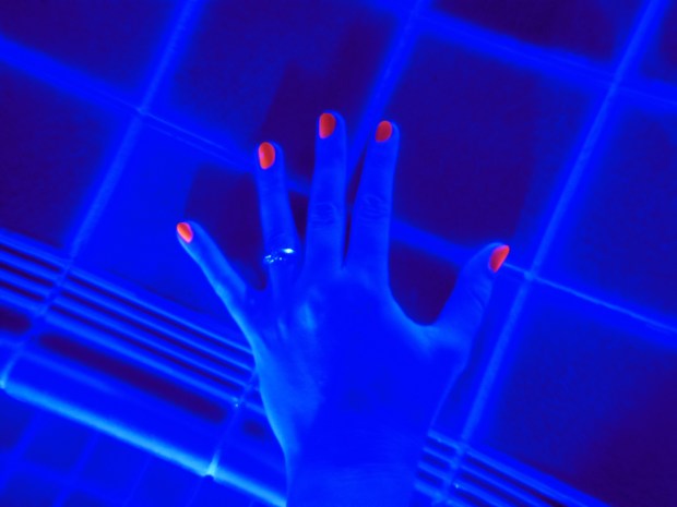 Bright orange manicure in blue pool