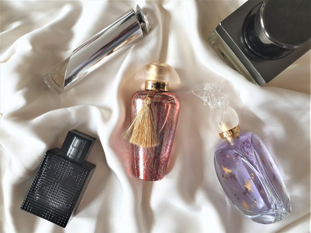 Perfume bottles on cream silk fabric