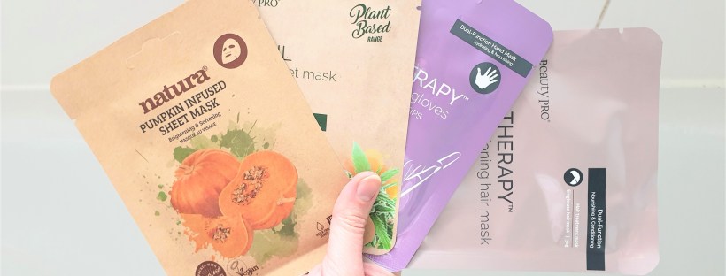 Hand holding four sheet masks